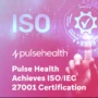 Finger touching a digital gear icon with a checkmark over a pink-purple gradient, plus the Pulse Health logo and the text “Pulse Health Achieves ISO/IEC 27001 Certification.”
