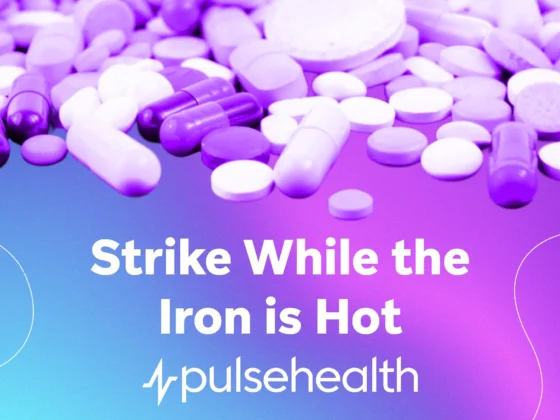 Assorted capsules and tablets scattered over a blue-to-purple gradient background with the text “Strike While the Iron Is Hot” and the Pulse Health logo.