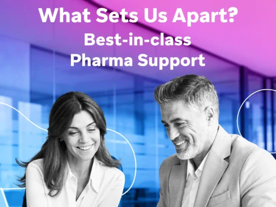 Two smiling professionals in business attire collaborate at a desk in a glass-walled office tinted with pink and purple hues, with large white text above asking “What Sets Us Apart?”