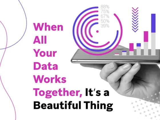 Hand holding a smartphone displaying overlayed circular and bar charts with the text “When All Your Data Works Together, It’s a Beautiful Thing.”